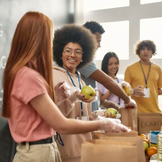 volunteers packing paper bags